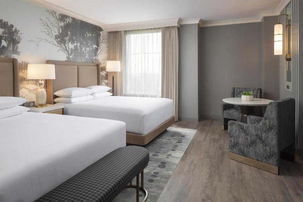 a hotel room with two beds and a desk at Grand Hyatt Atlanta in Buckhead in Atlanta