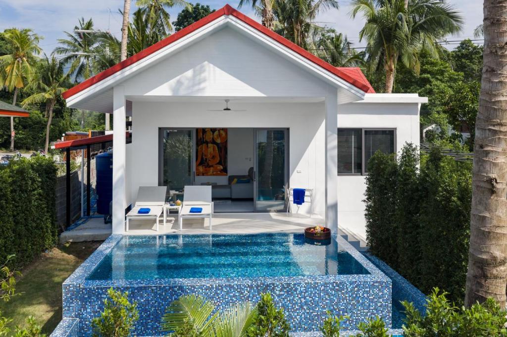 a villa with a swimming pool in front of a house at Buddha Bliss Luxury Villa in Ban Madua Wan