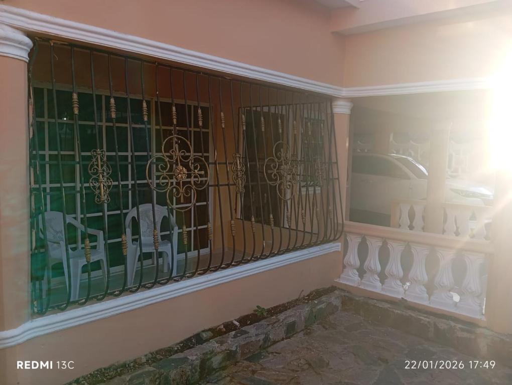 a room with a fence with a car in a window at Casa vacanza, Mendosa in Bayaguana