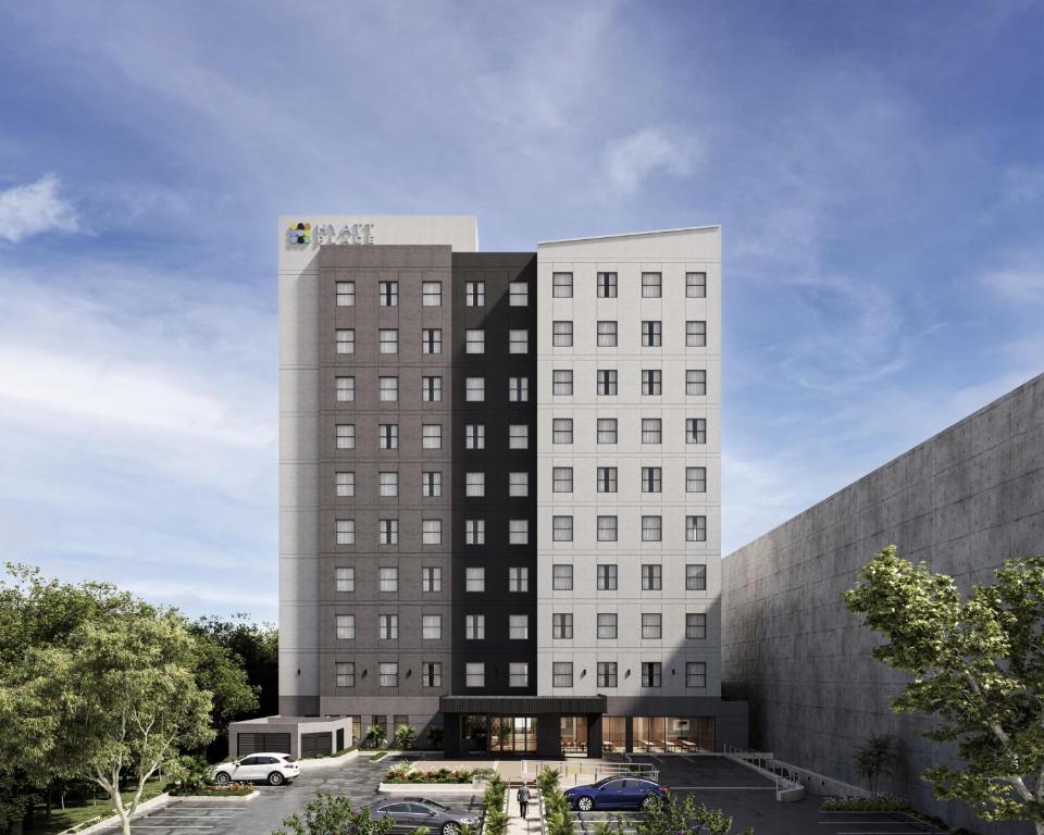 a rendering of a hotel building with a parking lot at Hyatt Place Merida/ Via Montejo in Mérida