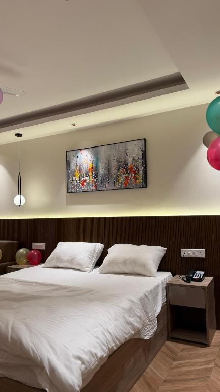 a bedroom with a bed and a painting on the wall at Cozy haven in Greater Noida