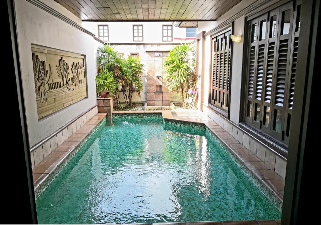 a swimming pool in the middle of a building at GLX Private Pool Villa in Port Dickson