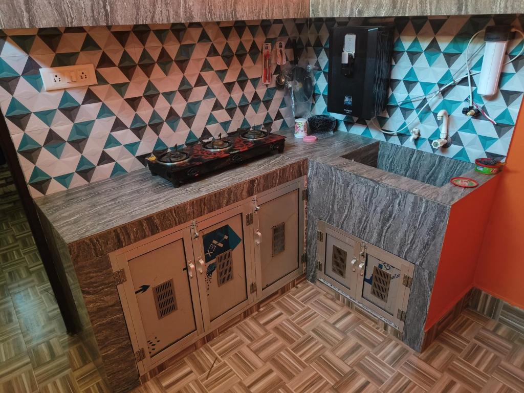 a kitchen with a sink and a counter top at Abhishek Homestay in Dum Duma