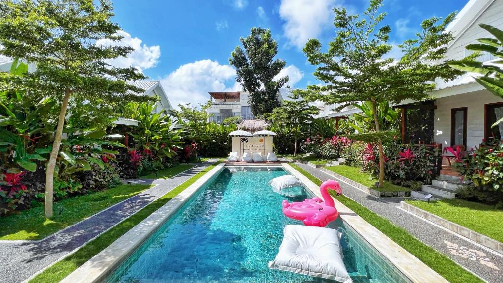 a pool with a pink flamingo in a house at Bacana Bungalows in Uluwatu
