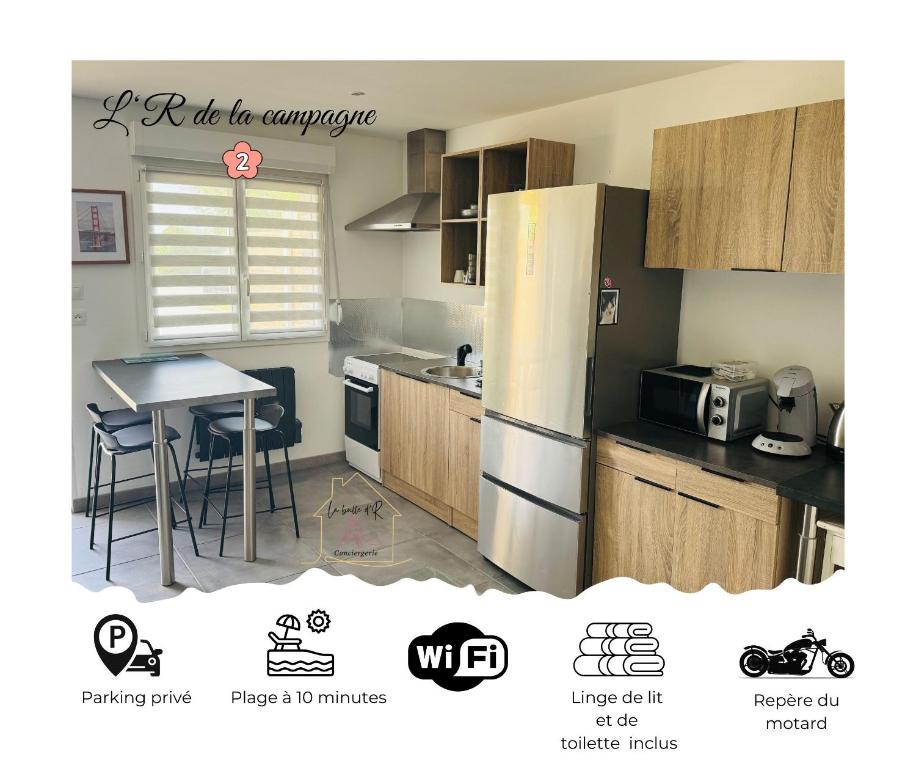 a kitchen with a refrigerator and a table with chairs at Le repaire 2 in Saint-Omer-Capelle