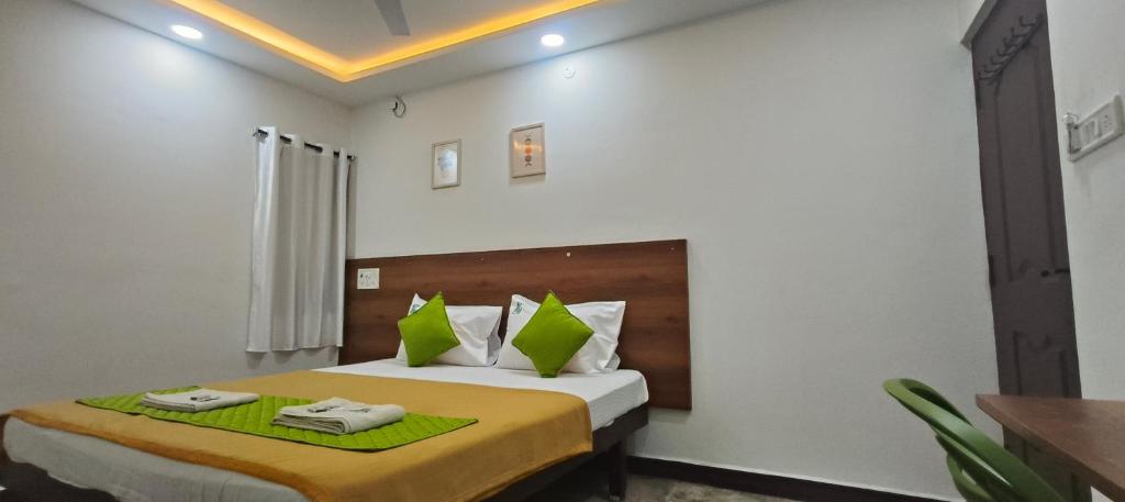 a bedroom with a bed with two towels on it at Hotel Royal Green Inn in Chennai