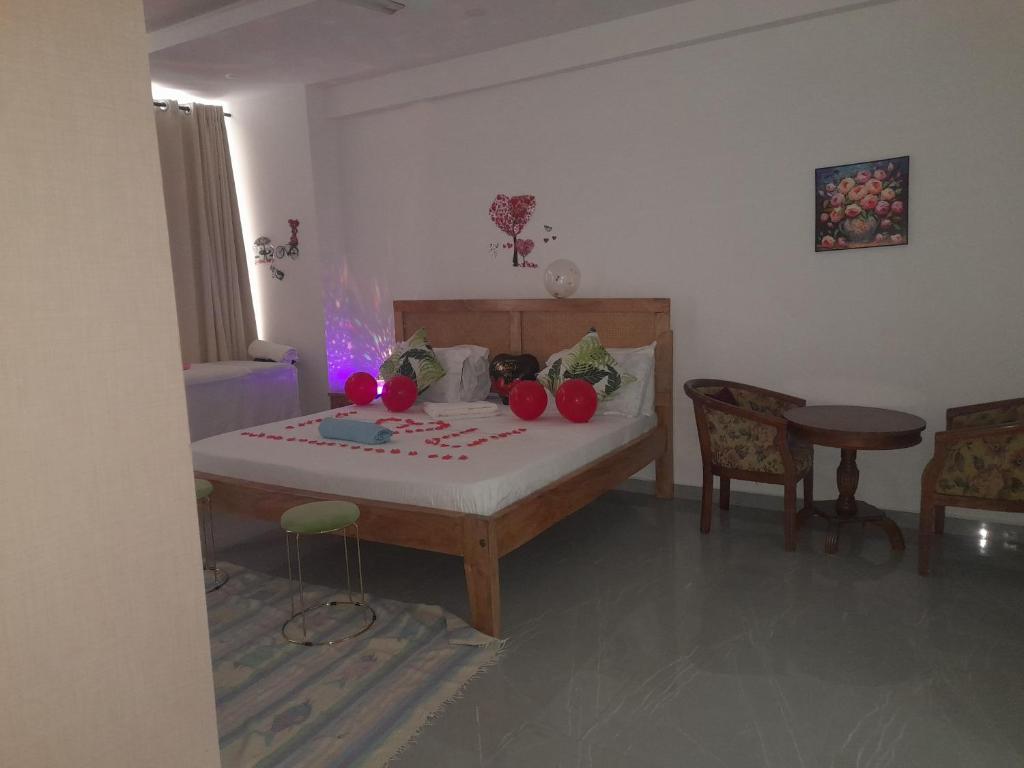 a bedroom with a bed with tomatoes on it at Aqua Garden Building in Nyali