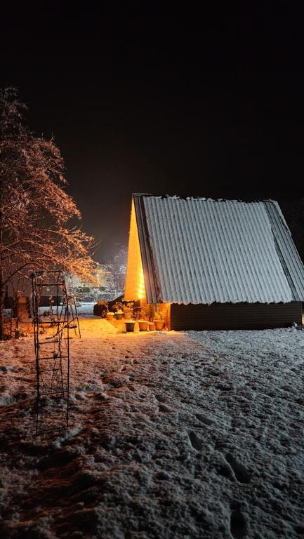 a barn at night with snow on the ground at Ecohouse Machakhela in Machakhela