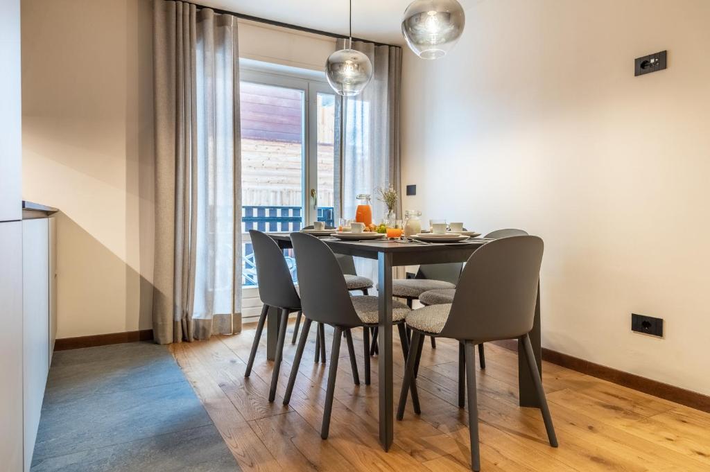 a dining room with a table and chairs at HelloCHALET - Front Row with balcony overlooking the Cretaz slopes in Breuil-Cervinia