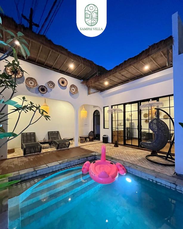 a house with a swimming pool with an inflatable rubber duck at Sampai Villa Prambanan in Randugunting