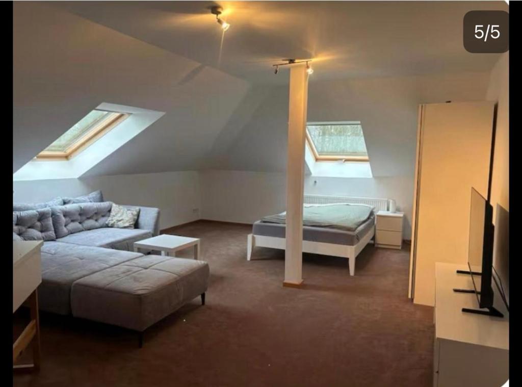 a living room with a couch and a bed at Monteur-, Ferienzimmer in Ibbenbüren