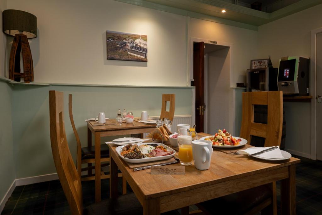 a table with plates of food on top of it at The Trout Fly Guest House in Port Ellen
