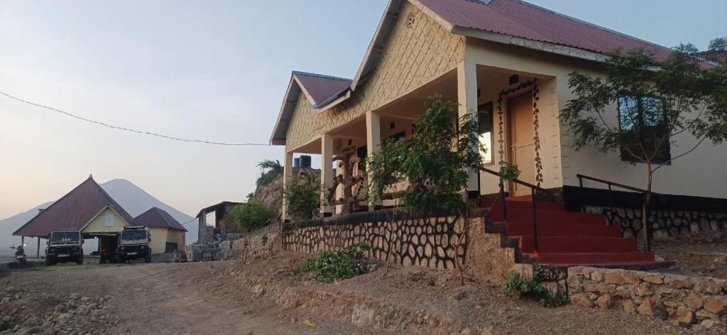 a house on the side of a dirt road at Eagle Nest lake Natron Lodge in Mtowabaga
