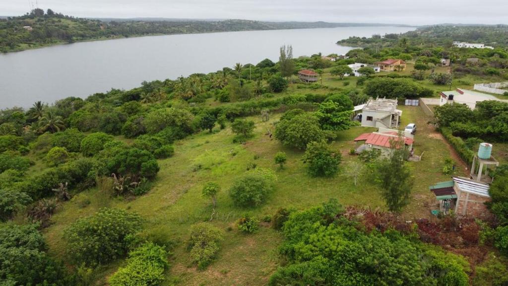 an aerial view of a house on a hill next to a lake at Nhambavale Niara House in Chidenguele