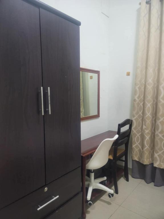 a room with a desk and a cabinet and a chair at Staycation in Tropez 924 in Manila