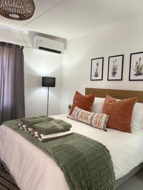 a bedroom with a large white bed with pillows at Willow - Cottage - Karoo in Prince Albert