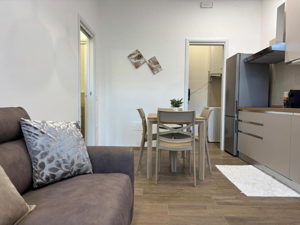a living room with a couch and a table and a kitchen at SARA - interno 1 - Premium Villas in Giulianova
