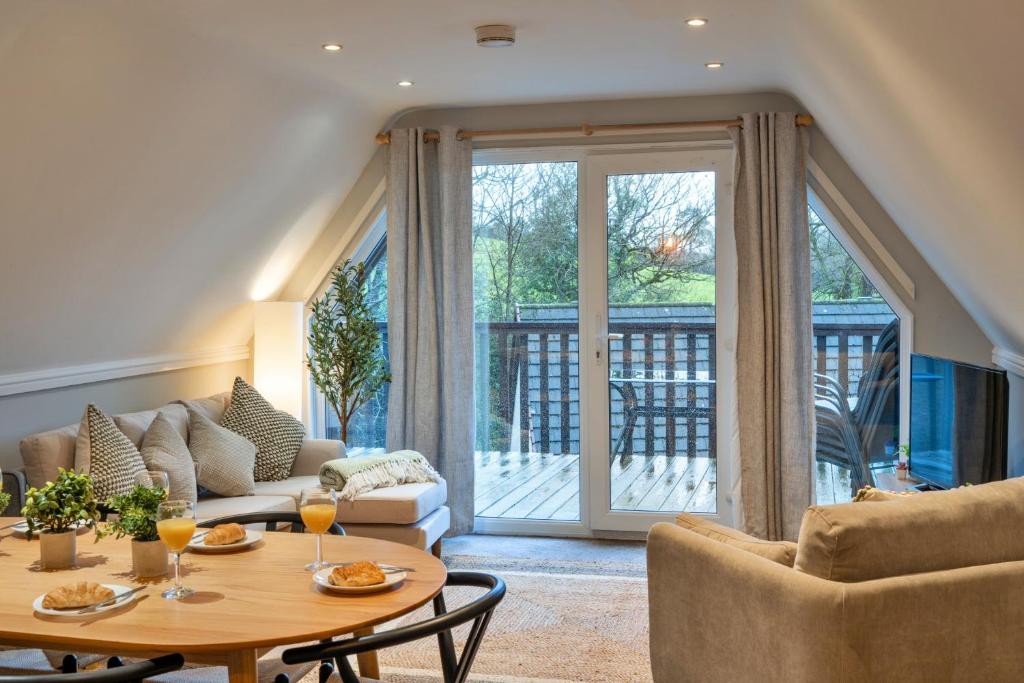 a living room with a couch and a table at Finest Retreats - Toblerone Lodge in Callington