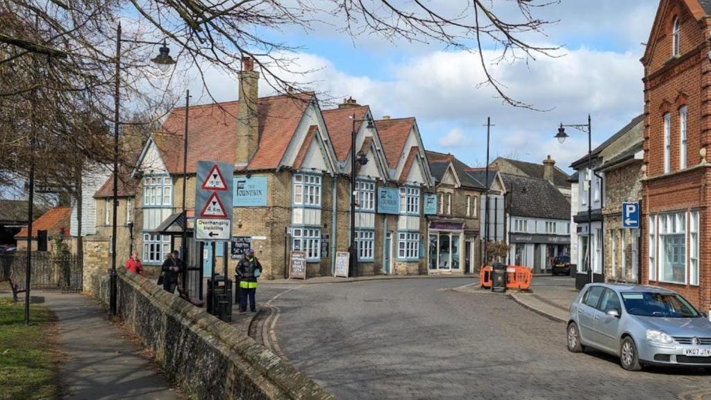 a street in a town with a car on the road at The Fountain in Soham