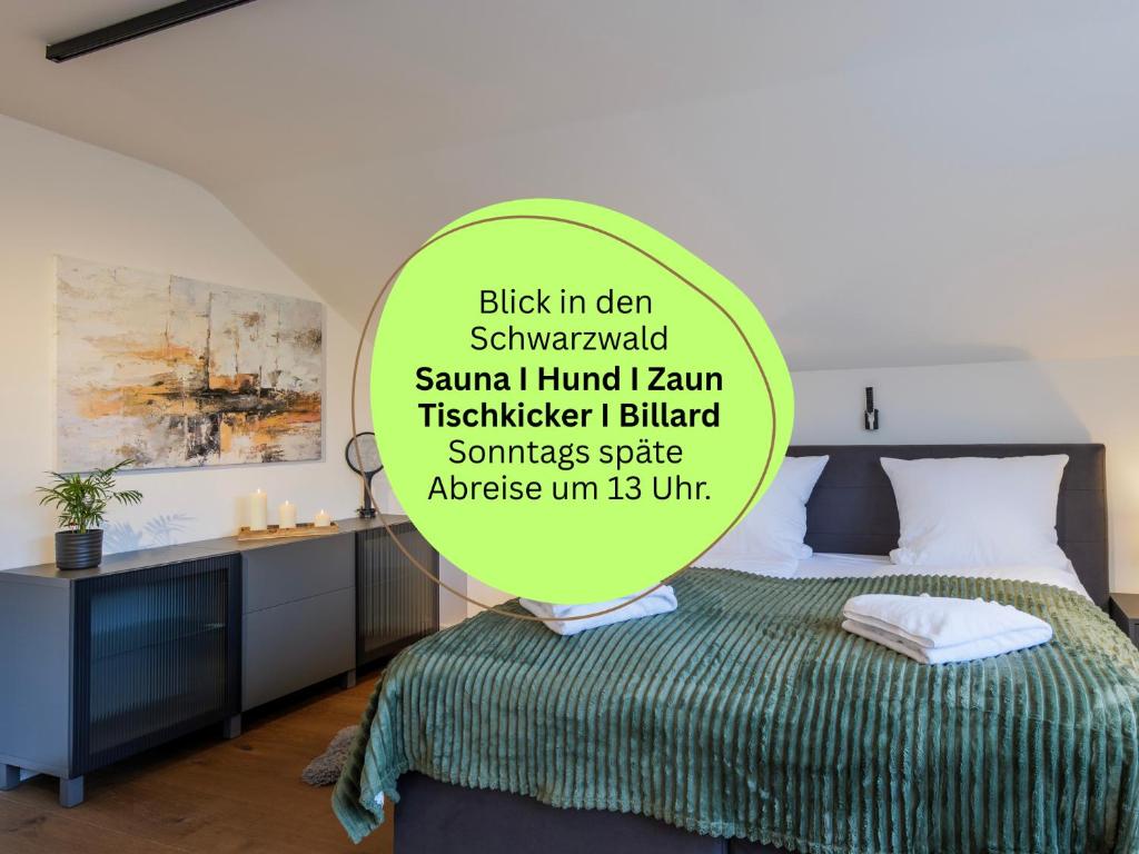 a bedroom with a bed and a sign that readsigunigunigun at Waldklang Panorama - eingezäunt - Außen-Sauna - T-Fußball - Billard - Hunde willkommen in Alpirsbach
