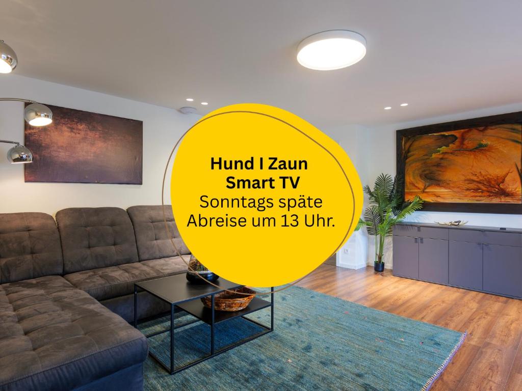 a living room with a couch and a table at Waldklang - Refugio - Hund - Zaun - Smart in Alpirsbach