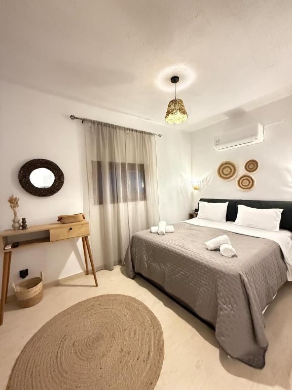 a bedroom with a large bed and a window at Dvillas one bedroom apartment in Svoronata