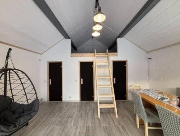 a room with a ladder in the middle of a room at Mini Хаус Ясіня in Yasinya