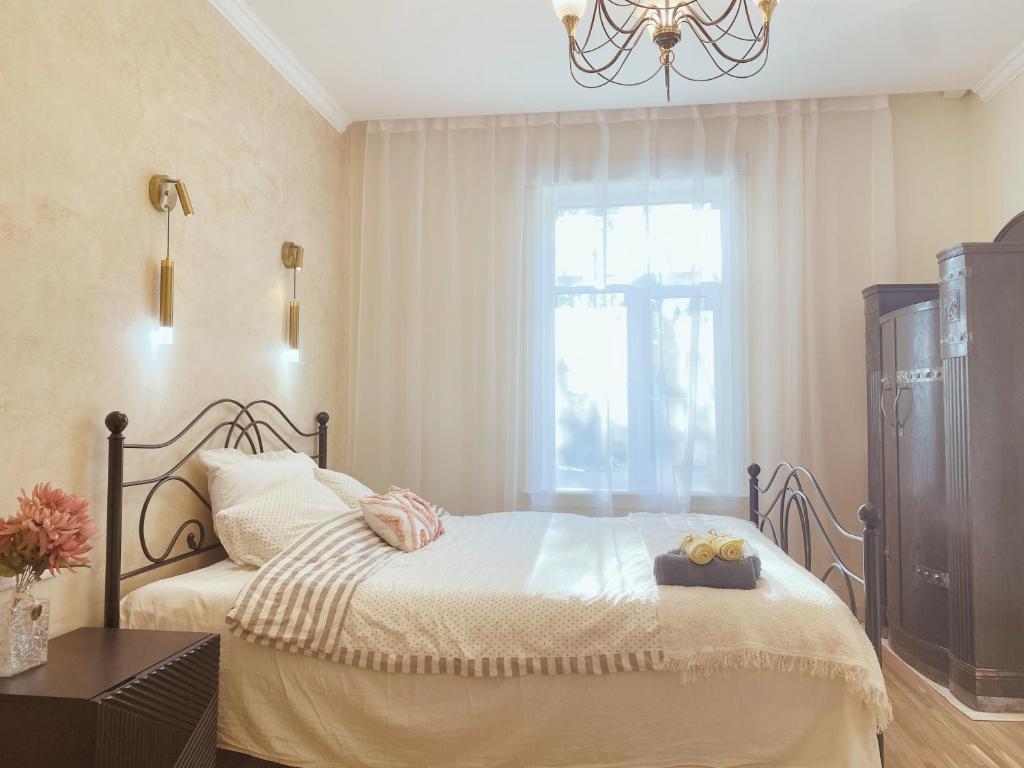 a bedroom with a bed and a window at Romantic Old Town Hideaway in Haapsalu