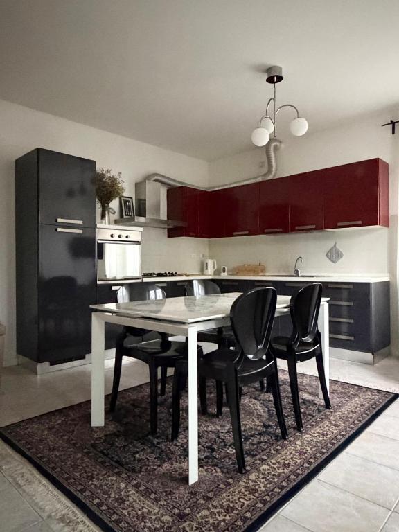 a kitchen with a table and chairs and a black refrigerator at Posticino apartment in Soave