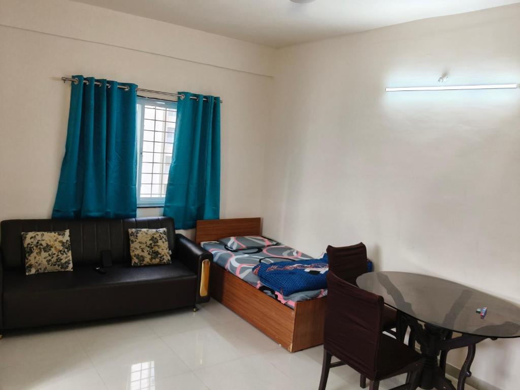 a living room with a bed and a table at Prolife Tathwade in Méribel Village