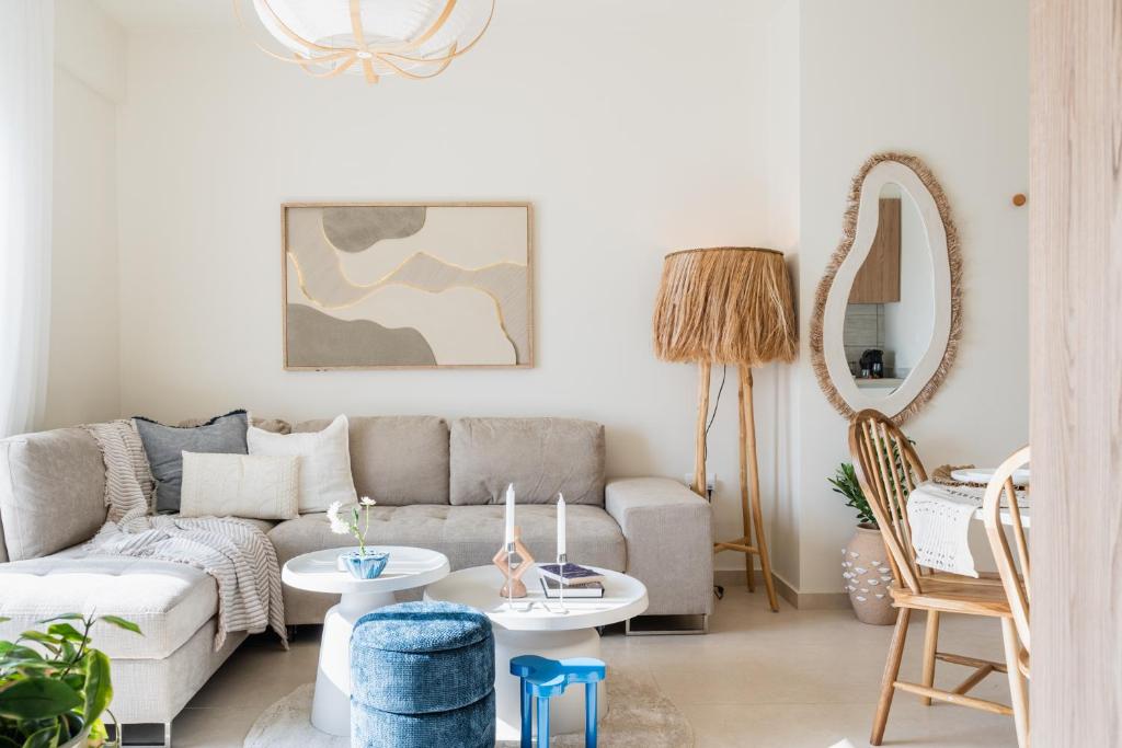 a living room with a couch and a table at Compass 1-BR Apartment by Makenzy Beach in Larnaca