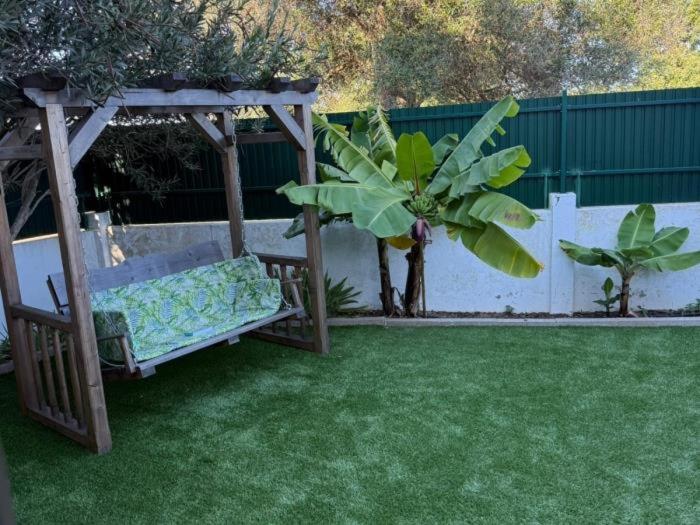 a gazebo with a bench in a yard at CHESA RUISA in Castro Marim