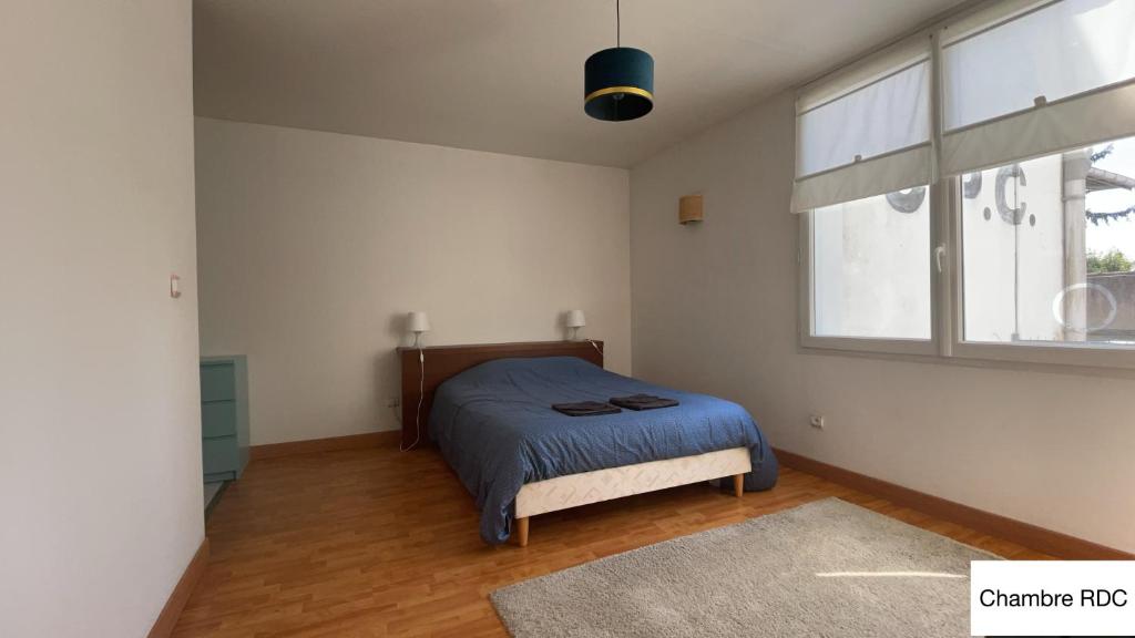 a bedroom with a bed and a window at test in Saint-Avertin