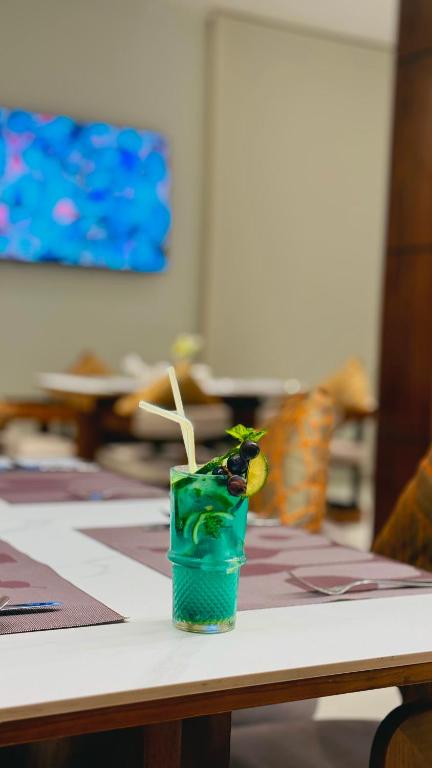 a green drink sitting on top of a table at Zabibu Hotel in Dodoma