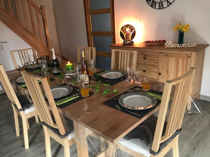 a wooden table with four chairs and a dining room at Le chalet des forges in Mairé