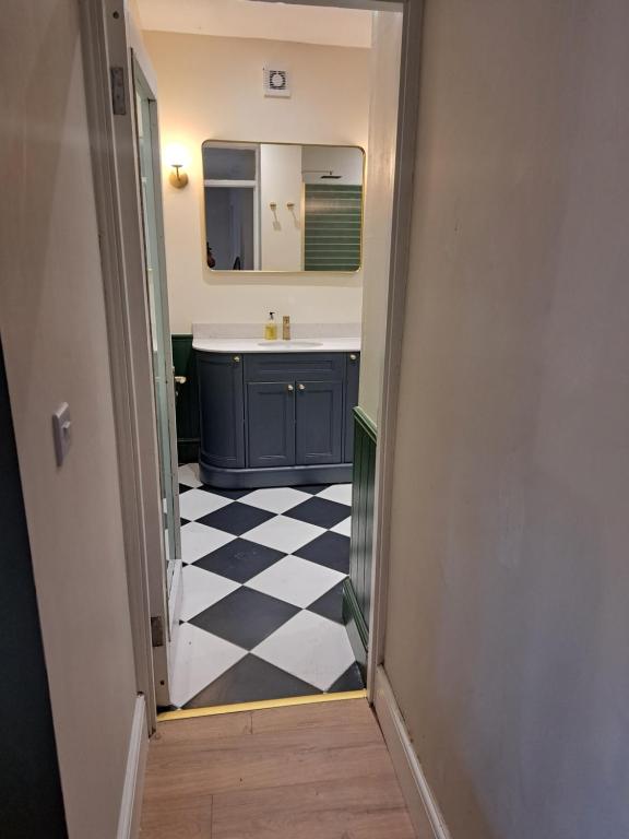 a bathroom with a sink and a checkered floor at Glendun in Dublin