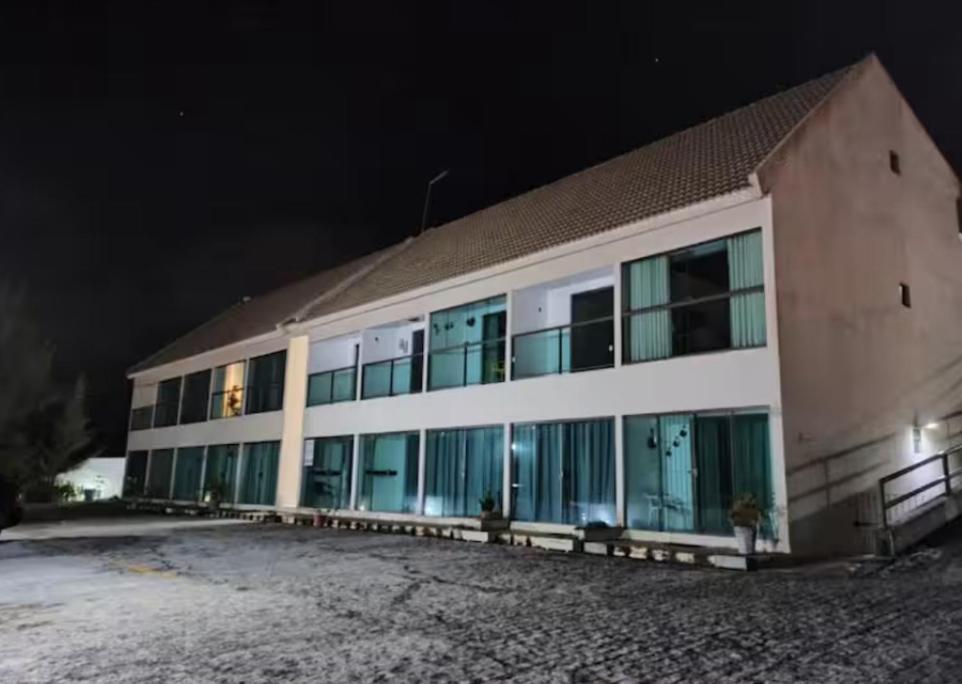 a large building with blue windows at night at Flat em Gravatá in Gravatá