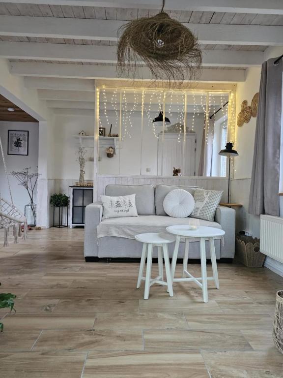 a living room with a couch and a table at L'envol des oies in Braives