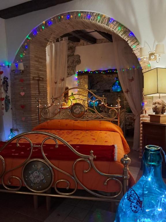 a bedroom with a bed with an arch with christmas lights at AL CANTINONE in Toffia