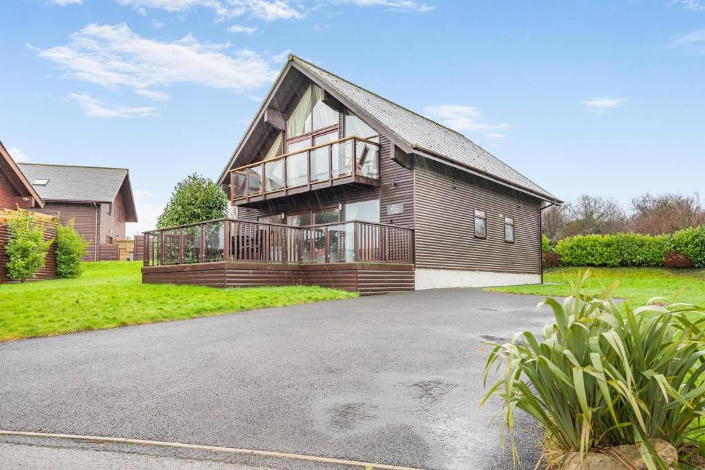 a house with a large deck on the front of it at 4 Bed in Winnards Perch oc-w34023 in Saint Columb Major