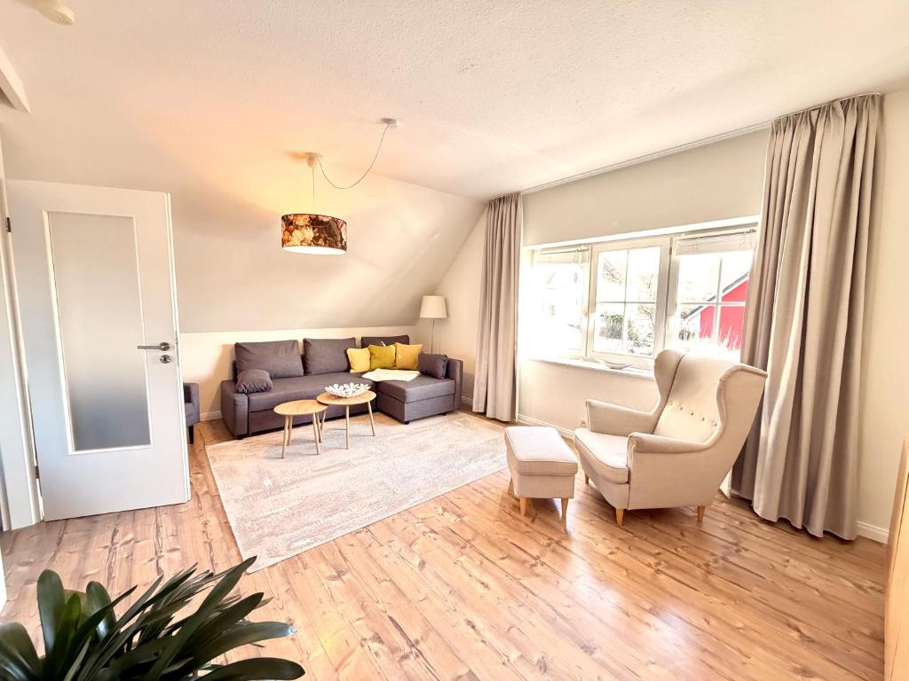 a living room with a couch and a chair at Ferienhaus 1 Fuchsweg in Stralsund