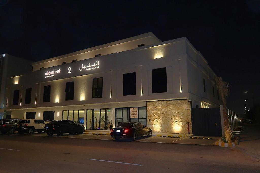 a building with cars parked in front of it at night at Albateel 2 Serviced Apartments-اقتصادي in Riyadh