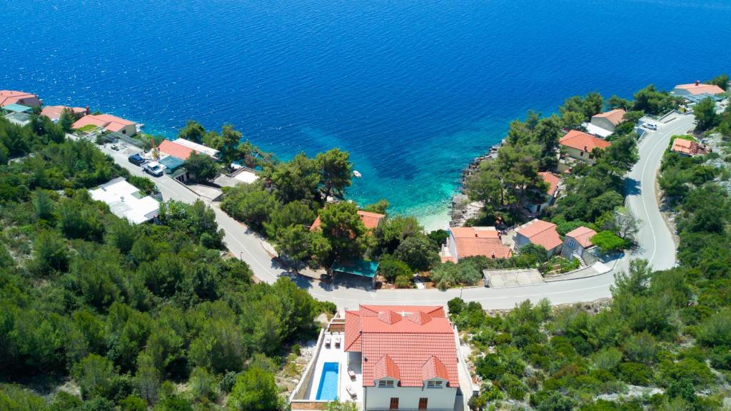 an aerial view of a house on a hill next to the water at Villa Julija by Villas Guide in Smokvica