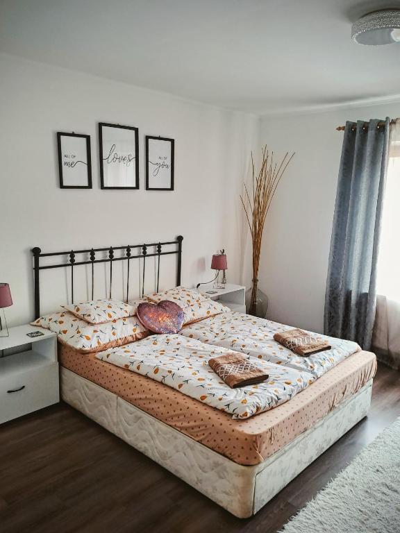a bed in a bedroom with two pillows on it at No°21 Apartman in Szilvásvárad