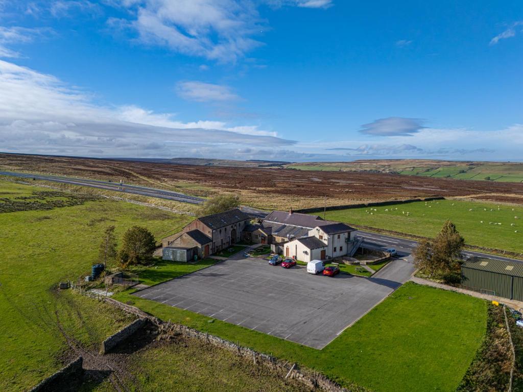 an aerial view of a house in a field at The Dog and Partridge in Langsett