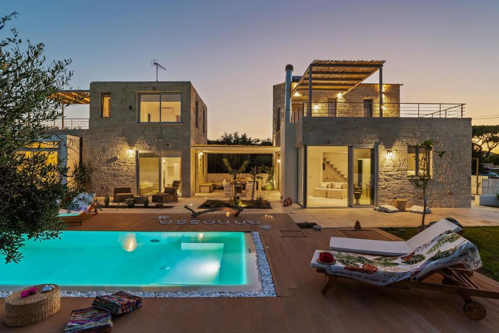 a villa with a swimming pool and a house at Annassa Experience Villa 2' walk from Almyrida beach in Almyrida