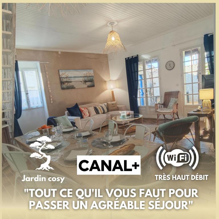 a living room with a couch and a table at Le Clos de Saint Georges in Saint-Georges-dʼOléron