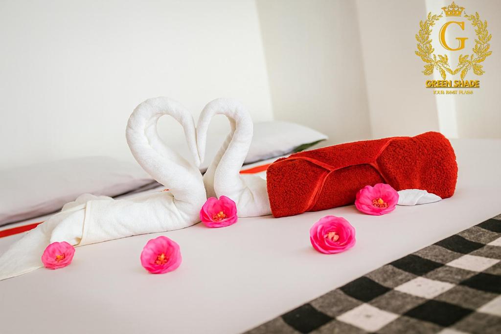 two swans made out of towels on a bed at Green Shade Resort & Haritha Sewana Hotel in Nallathanniya
