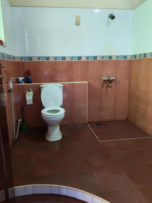 a bathroom with a white toilet in a stall at Nice place in Marawila