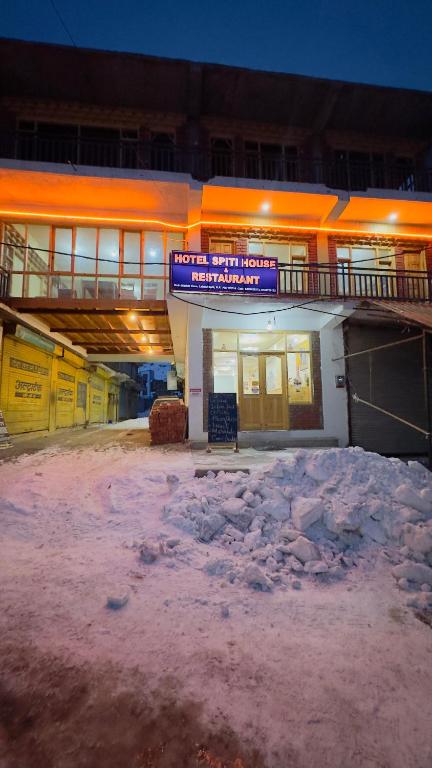 a building with snow in front of it at night at Hotel Spiti House in Kaza